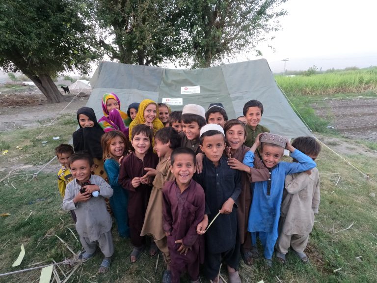 Children in Pakistan stand together and pose for the camera in Pakistan.